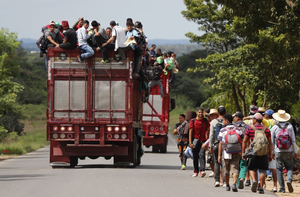 Central American migrants, part of the caravan hoping to reach the U.S. border, get a ride on a truck, in Isla, Veracruz state, Mexico, Nov. 3.