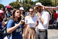 A volunteer tourism ambassador helping out two tourists.