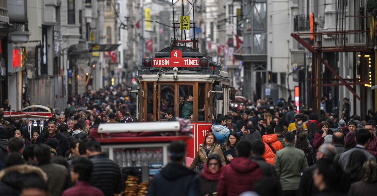 A tramway drives through a crowd in u0130stiklal Avenue, Istanbul, Jan. 25, 2019. (AFP Photo)