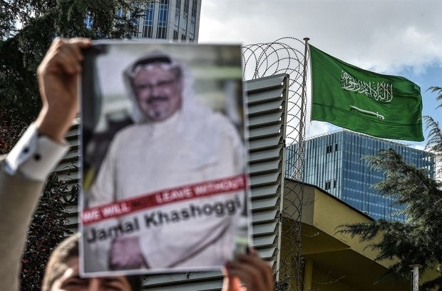 A protester holds a poster with a picture of Jamal Khashoggi outside Saudi Arabia's Consulate in Istanbul.