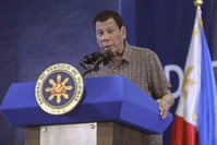 In this Jan. 23, 2020, photo provided by the Malacanang Presidential Photographers Division, Philippine President Rodrigo Duterte delivers his speech at the San Isidro Central School during the distribution of benefits to former rebels in Leyte province, southern Philippines. (Malacanang Presidential Photographers Division via AP)