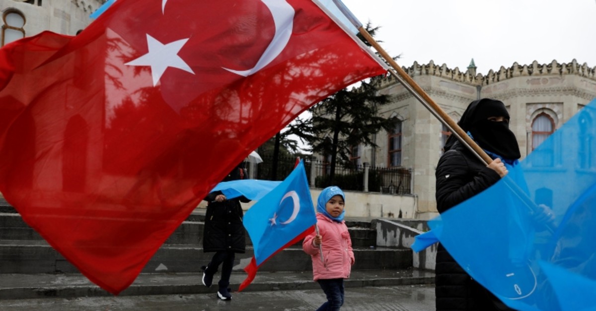 This file photo shows ethnic Uighur demonstrators hold East Turkestan and Turkish flags during a demonstration against China in Istanbul, Turkey, February 23, 2019. (Reuters Photo)