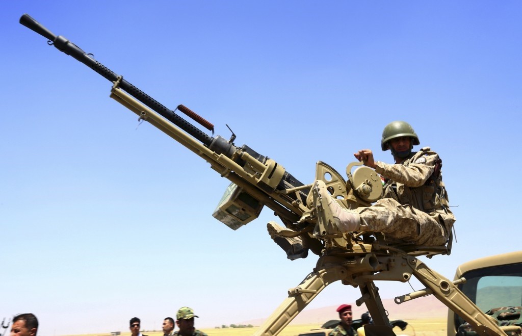 A member of the Kurdish peshmerga forces sit with a weapon during an intensive security deployment against Daesh terrorists in Makhmur, on the outskirts of the province of Nineveh August 7, 2014. (Reuters Photo)