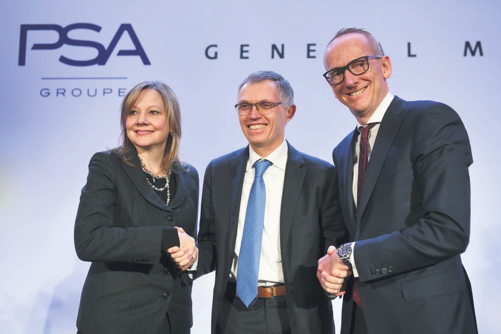 GM CEO Mary T. Barra, chairperson of the managing board of PSA Tavares and Opel CEO Neumann shake hands during a press conference about the acquisition by PSA of GMu2019s European subsidiary, which includes Opel and Vauxhall in Paris on March 6, 2017.