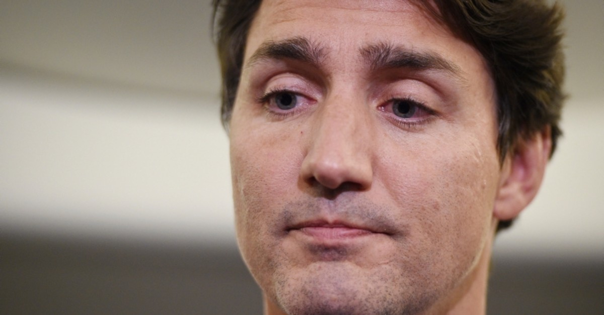 Canadian Prime Minister and Liberal Party leader Justin Trudeau makes a statement in regards to a photo of himself from 2001, wearing brownface, during a scrum on his campaign plane in Halifax, Nova Scotia, Sept. 18, 2019. (The Canadian Press via AP)