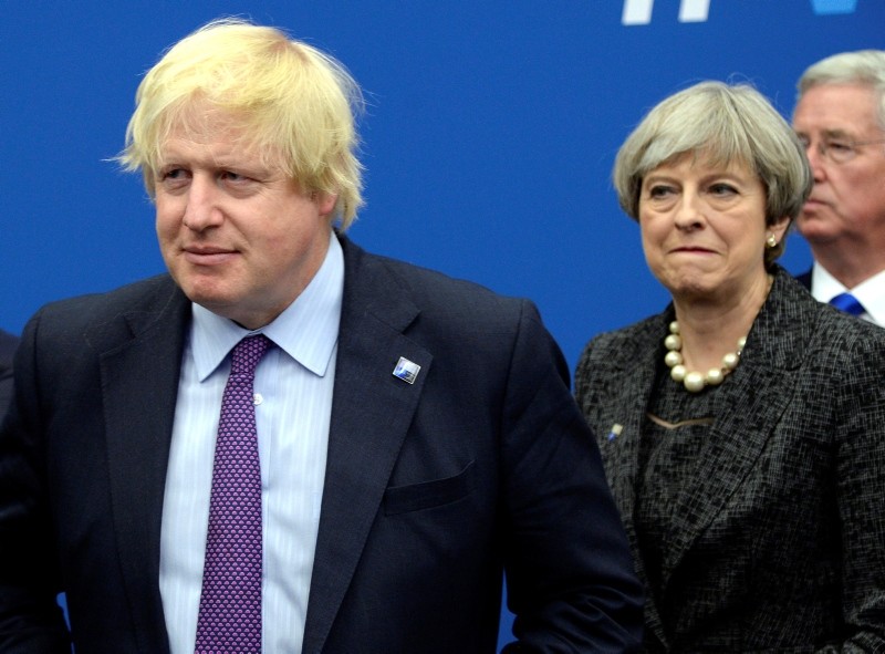 In this, May 25, 2017 file photo British Foreign Secretary Boris Johnson, left, and Britain's PM Theresa May arrive for a meeting during the NATO summit of heads of state and government in Brussels. (AP Photo)