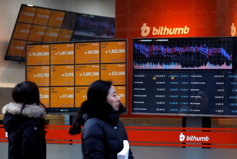 People look at monitors displaying cryptocurrency values at Bithumb, one of South Korea's biggest digital currency exchanges, in Seoul. (EPA Photo)