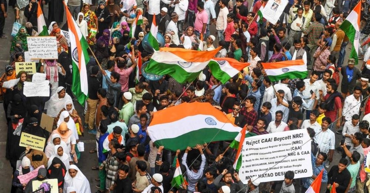 Protesters hold placards and national flags as they take part in a demonstration against India's anti-Muslim citizenship law, Kolkata, Jan. 21, 2020. (AFP Photo)