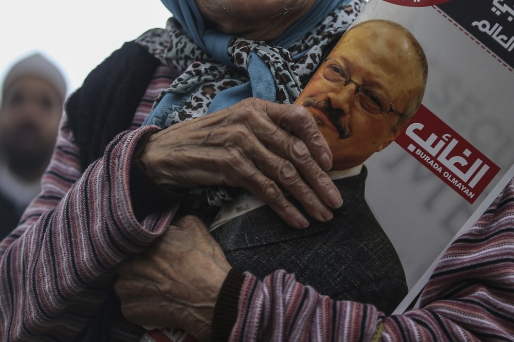 A woman holds a poster during the funeral prayers in absentia for Saudi writer Jamal Khashoggi who was killed last month at the Saudi Consulate in Istanbul, Nov. 1.
