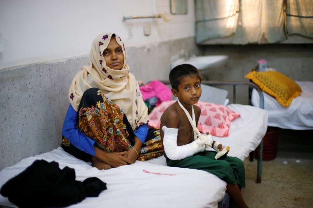 Faisal, 6, a Rohingya refugee who broke his hand while fleeing Myanmar, is treated at the Cox's Bazar District Sadar Hospital, Cox's Bazar, Bangladesh.