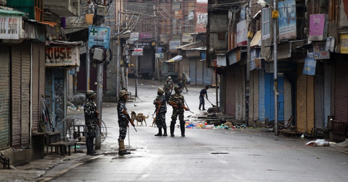 Indian paramilitary soldiers stand guard on a deserted street during the curfew in Srinagar, Kashmir, Aug. 8, 2019. 