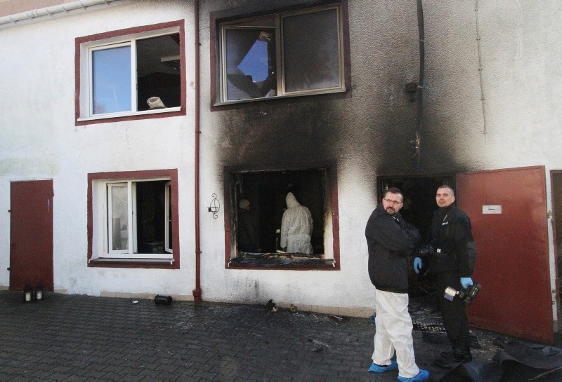Forensic and other police experts examine the site of a fire in an Escape Room, in Koszalin, northern Poland, on Saturday, Jan. 5, 2019. (AP Photo)