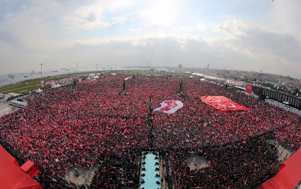Turkish people waving the national flag and 'yes' banners as President Erdou011fan delivers a speech during a rally for the constitutional referendum at the Yenikapu0131 Square in Istanbul, April 8.