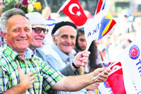 People wave Turkish and Bosnian flags at an opening ceremony for a project by the Turkish Cooperation and Coordination Agency (Tu0130KA) in Bosnia.