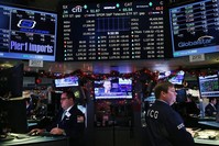 Traders work on the floor of the New York Stock Exchange in New York City, March 25, 2015.