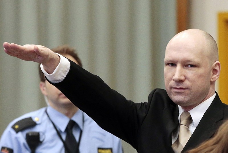 Convicted mass killer Anders Behring Breivik gestures as he enters the court room in Skien prison, Norway, 15 March 2016. (EPA Photo)