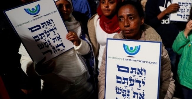 African migrants hold signs Hebrew signs: ,You come from the Bible, you too are refugees,, during a demonstration in Tel Aviv (AFP File Photo)