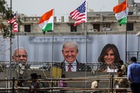 Policemen stand guard near the billboard showing (L-R) India's Prime Minister Narendra Modi, U.S. President Donald J. Trump and first lady Melania Trump, outside the Sardar Patel Gujarat Stadium ahead of an upcoming state visit by the U.S. president, in Ahmedabad, India, Feb. 23, 2020. (EPA Photo)