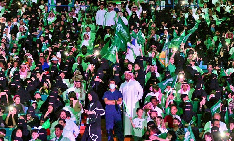 In this Sept. 23, 2017 file photo released by Saudi Press Agency, SPA, Saudi men and women attend national day ceremonies at the King Fahd stadium in Riyadh, Saudi Arabia (AP File Photo)