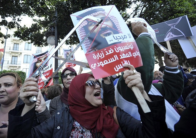 Tunisian protesters holding placards with inscription reading in Arabic 'Tunisians against Saudi Crown Prince visit' shout slogans during a protest in Tunis, Tunisia, Nov. 27, 2018. (EPA Photo)