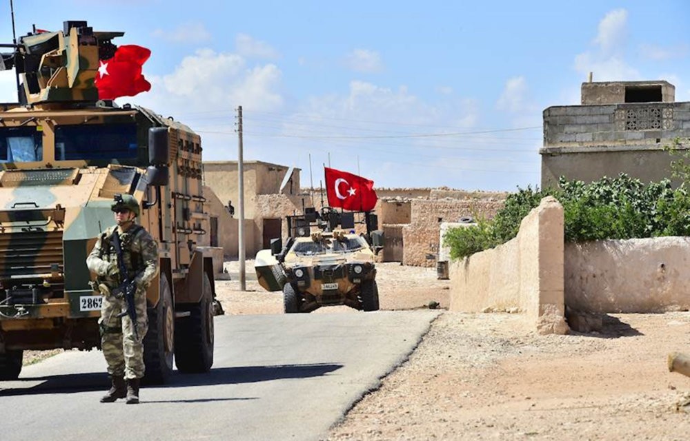 Turkishsoldiers accompanied by armored vehicles patrolling between the city of Manbij in northern Syria and an area it controls after a 2016-2017 military incursion, June 18.