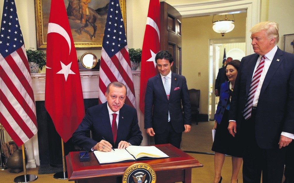 President Erdou011fan signs on the U.S. guest book in the Oval office of the White House during his first visit to Washington since Donald Trump became the president, May 16.
