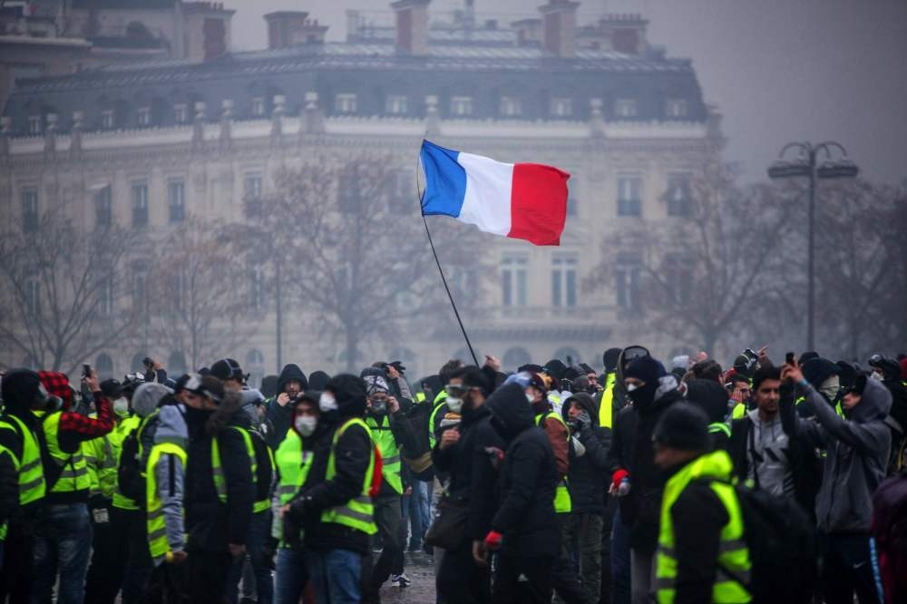 Demonstrators gather near the Arc de Triomphe in central Paris during a protest by the ,yellow vest, movement against rising fuel prices and living costs, Paris, Dec. 1. 