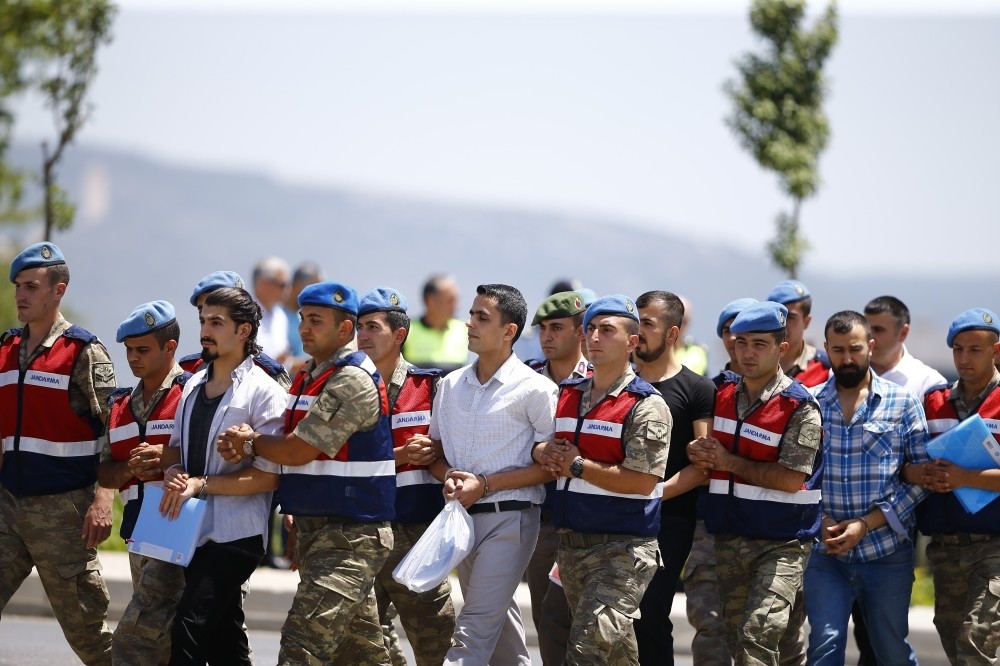Gendarmerie troops escort defendants to the courtroom in Muu011fla for a trial on the assassination attempt of President Recep Tayyip Erdou011fan.