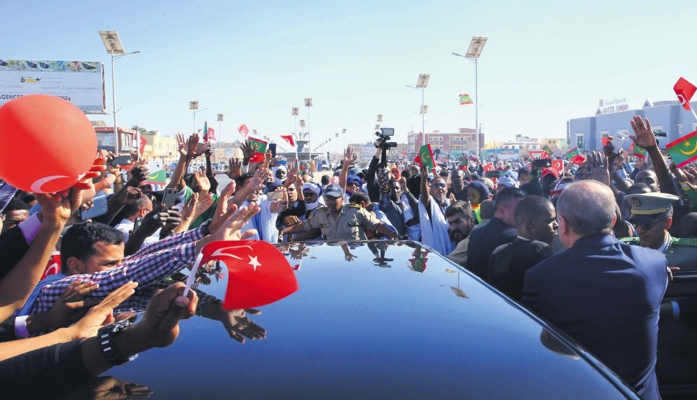 Turkish and Mauritanian security officers and people surround the car of President Erdou011fan (R) as he gestures during a welcome ceremony at the airport in Nouakchott, Mauritania, Feb. 28. 