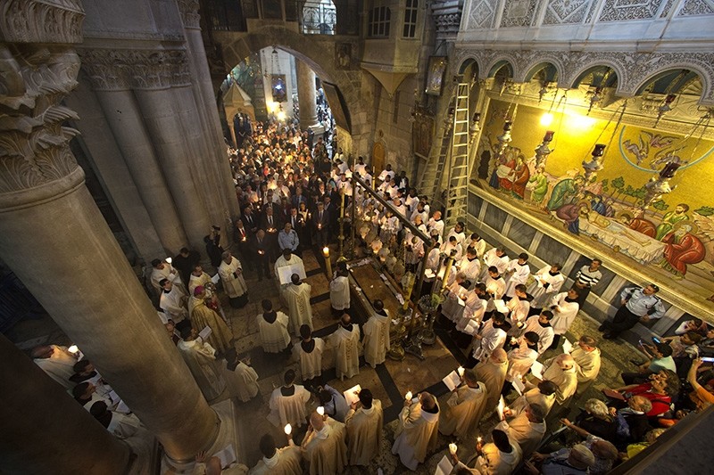 Christian clergymen hold candles during the Easter Sunday procession at the Church of the Holy Sepulchre, traditionally believed by many Christians to be the site of the crucifixion and burial of Jesus Christ, in Jerusalem, Sunday, April 16, 2017 (AP