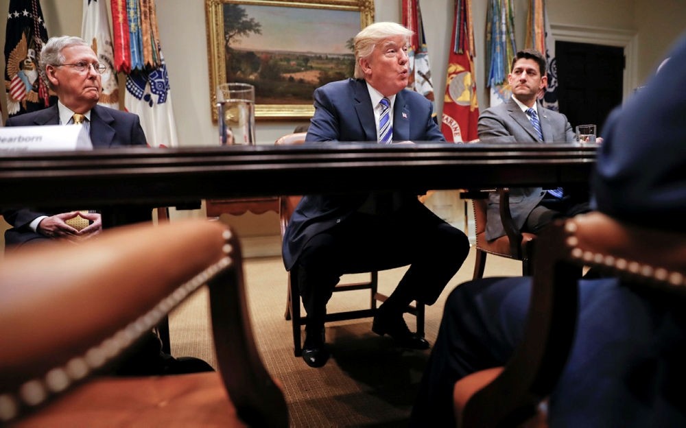 President Donald Trump, flanked by Senate Majority Leader Mitch McConnell of Ky., left, and House Speaker Paul Ryan of Wis., speaks at the White House in Washington. (AP Photo)