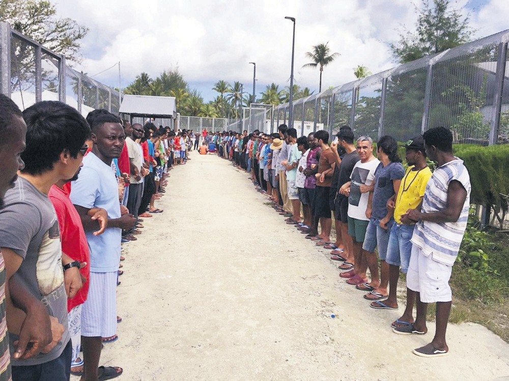 Refugees links hands in solidarity ahead of the center's closure at the Manus Island detention center, Papua New Guinea, Oct. 31.