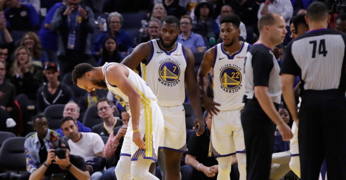 Golden State Warriors' Stephen Curry, left, grimaces after Phoenix Suns' Aron Baynes fell onto him during the second half of an NBA basketball game Wednesday, Oct. 30, 2019, in San Francisco. Curry left the game. (AP Photo)