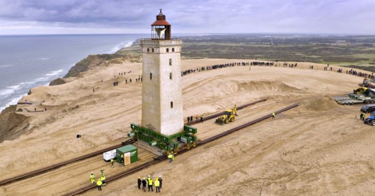 The Rubjerg Knude Lighthouse is being moved on tracks in Jutland, Denmark, Tuesday, Oct. 22, 2019. (AP Photo)