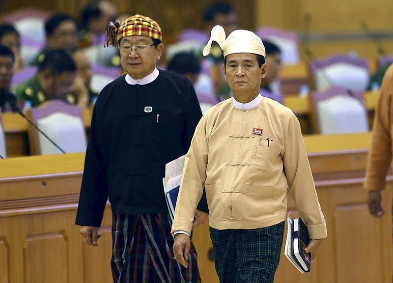 Win Myint, center, resigned Speaker of the Lower House Parliament, enters the parliament in Naypyitaw, Myanmar, Wednesday, March 28, 2018 (AP Photo)