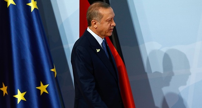 President Recep Tayyip Erdogan walks past the flags of the European Union (L) and Germany as he arrives for the G20 summit in Hamburg, Germany, July 7, 2017. (AFP Photo)