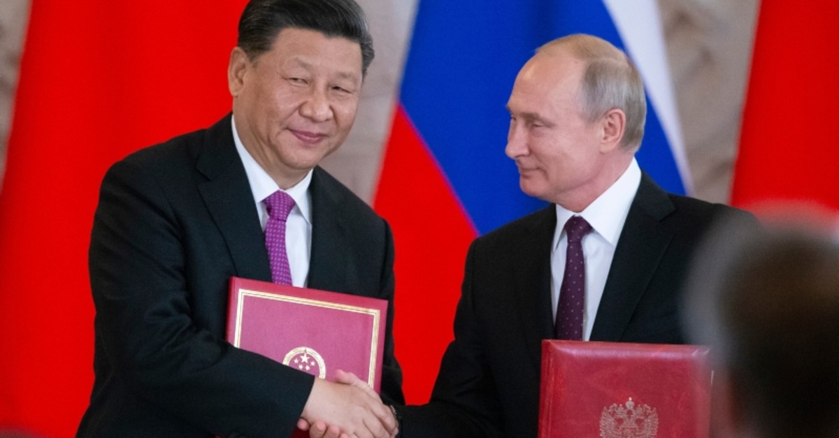 Russian President Vladimir Putin, right, and Chinese President Xi Jinping exchange documents during a signing ceremony following their talks in the Kremlin in Moscow, Russia, Wednesday, June 5, 2019. (AP Photo)
