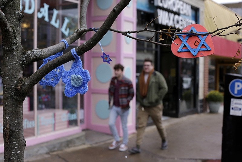 In this Nov. 20, 2018 photo, crafted Stars of David hang from a tree on Forbes Ave in the Squirrel Hill shopping district of Pittsburgh, where the deadliest attack on Jews in the recent history took place in October. (AP Photo)