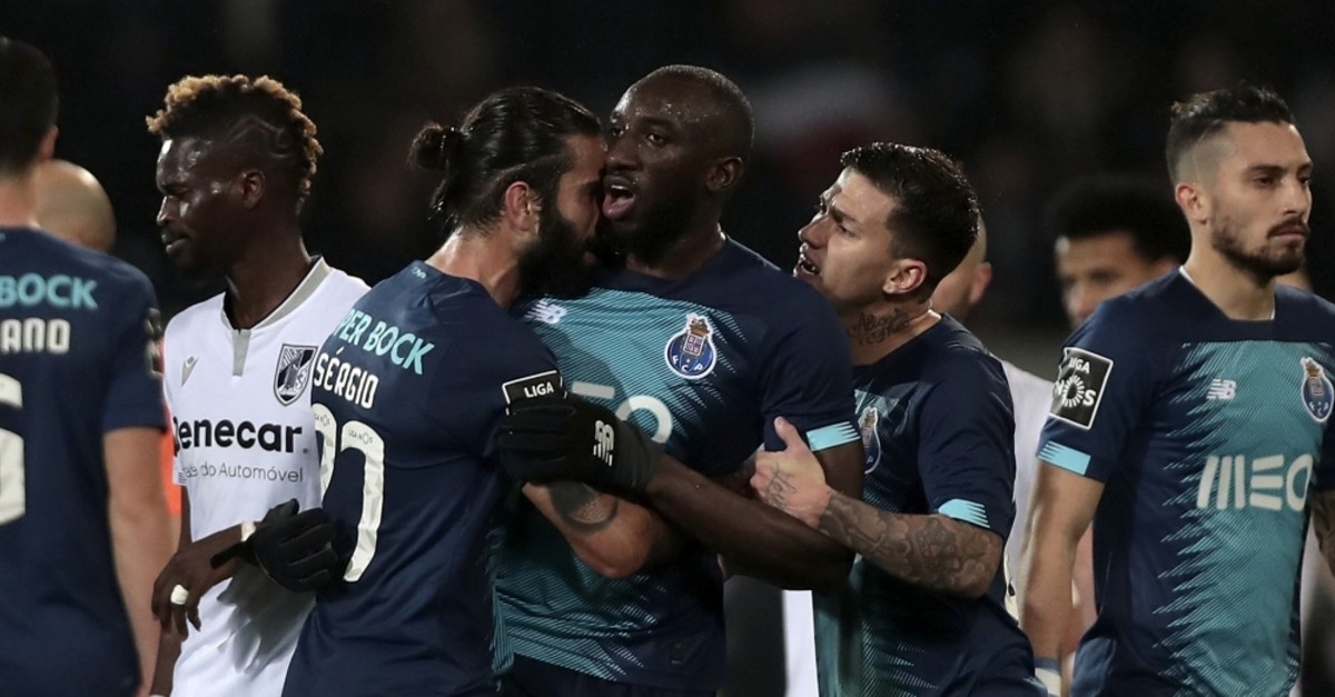 Porto's Sergio Oliveira, center left, and Otavio, center right, talk with teammate Moussa Marega, center, as he tries leaves the pitch after hearing monkey chants, Guimares, Portugal, Feb. 16, 2020. (AP Photo)