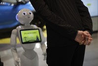 A guest asks robot Robby Pepper for information at the front desk of a hotel in Peschiera del Garda, Italy.