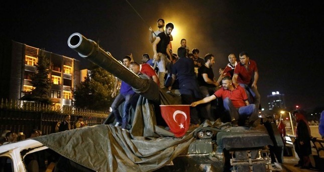 People stand on an army tank, used by Gu00fclenist coup officers during the attempt coup, Ankara, July 16, 2016.