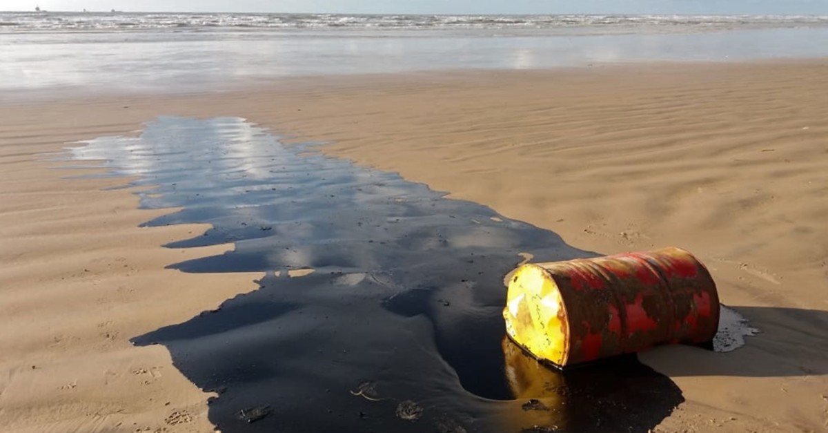 Handout picture released by the Sergipe State Environment Administration (Ademas) on Sept. 27, 2019, showing a barrel of oil spilled on a beach in Barra dos Coqueiros municipality, Sergipe state, Brazil. (AFP)