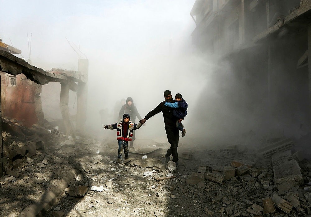 Syrian civilians flee from reported regime airstrikes in the besieged Eastern Ghouta region on the outskirts of the capital Damascus, Feb. 8.