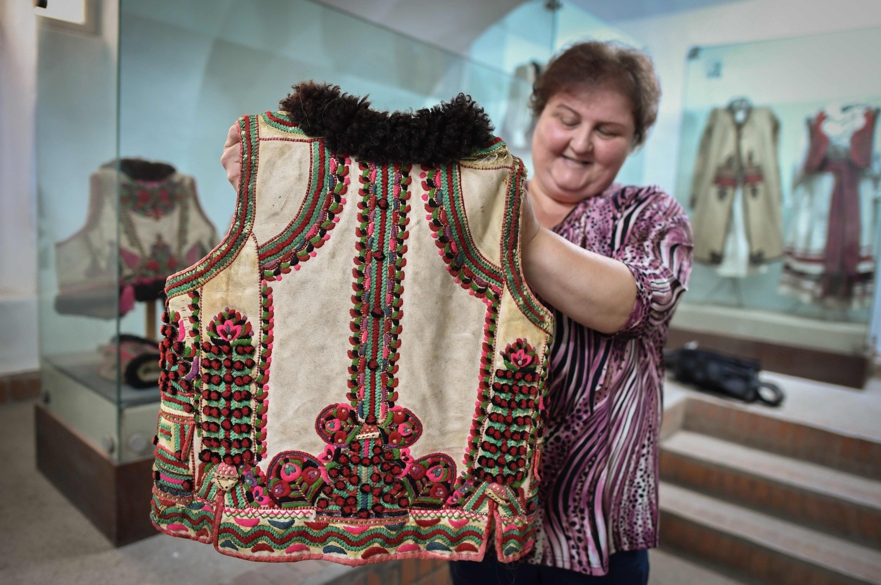 A woman working at the local museum shows a 100 year-old traditional outfit from the Bihor northwestern region of Romania in Beius, July 17.