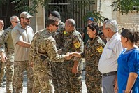 Members of the U.S.-led coalition forces shake hands with People's Protection Unit (YPG) terrorists in Tal Abyad, Sept. 15, 2019.
