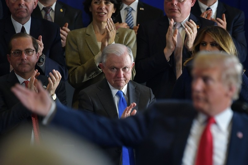 Attorney General Jeff Sessions (C) and First Lady Melania Trump (R) applaud as US President Donald Trump speaks about combating the opioid crisis at Manchester Community College in Manchester, New Hampshire. (AFP Photo)