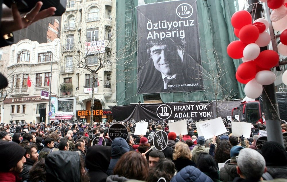 A crowd commemorating Hrant Dink gathered on Jan. 19, 2017, outside Agos weekly, against the backdrop of a poster of the late journalist.