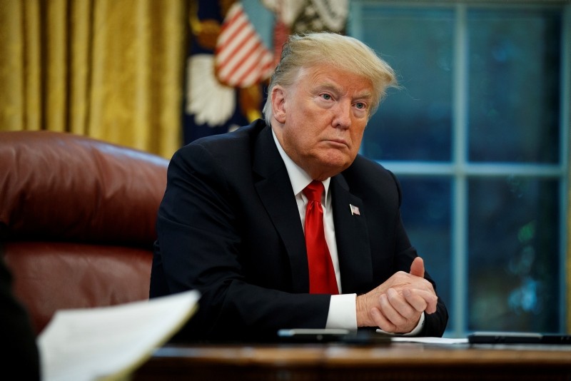 President Donald Trump listens to a question during an interview with The Associated Press in the Oval Office of the White House, Tuesday, Oct. 16, 2018, in Washington. (AP Photo)