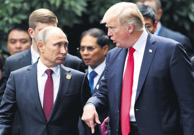 U.S. President Trump and Russia's President Putin talk during the family photo session at the APEC Summit, Danang, Vietnam, Nov. 11, 2017.