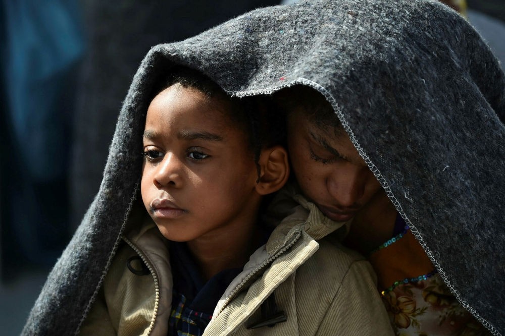 A woman and her daughter protect themselves with a blanket aboard a rescue ship a day after a rescue operation for migrants off the Libyan coast, May 25.